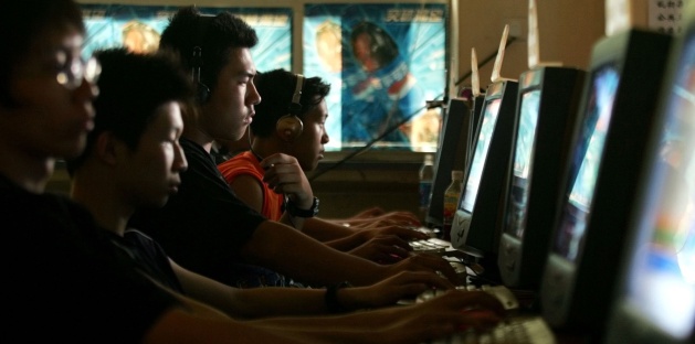 Chinese youths use computers at an Internet cafe in Beijing (AP Photo/Greg Baker, File).