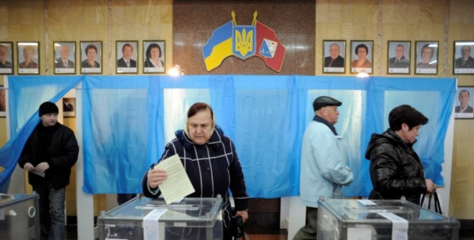 A woman casts her ballot at a polling station during the Crimean referendum, in Sevastopol, Ukraine, Sunday, March 16, 2014. Residents of Ukraine's Crimea region are voting in a contentious referendum on whether to split off and seek annexation by Russia. (AP Photo/Andrew Lubimov)