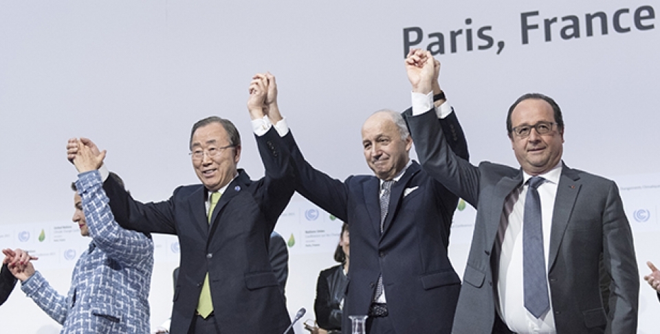 UN Secretary-General Ban Ki-moon, Christiana Figueres, Executive Secretary of the UNFCCC, Laurent Fabius, Minister for Foreign Affairs of France and President of COP21, and François Hollande, President of France celebrate after the historic adoption of Paris Agreement on climate change. (UN Photo/ Mark Garten)