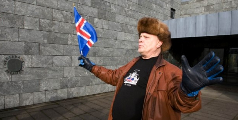 A protestor waves an Icelandic flag outside the Central Bank of Iceland during a demonstration in Reykjavik, Oct. 10, 2008 (AP Photo/Arni Torfason).