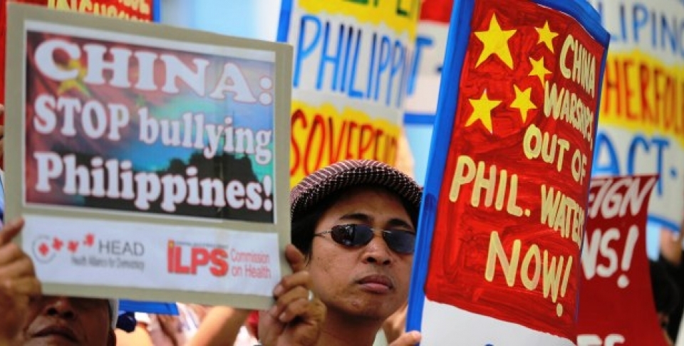 Filipino protesters hold placards with slogans outside the Chinese consulate at the financial district of Makati, south of Manila, Philippines on April 22, 2014. The group is demanding an end to China's alleged incursions in the South China Sea and to press the Chinese government to respect the arbitral process under the United Nations Convention on the Law of the Sea. (AP Photo/Aaron Favila)