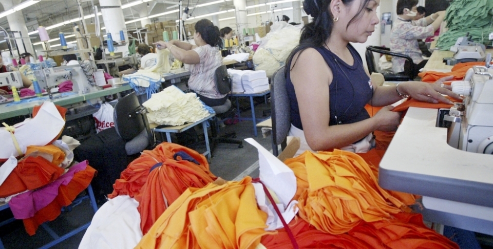 Workers sew at an American Apparel factory in Los Angeles. In an industry with a history of sweatshops, American Apparel is one of two Los Angeles firms convinced it can make money without underpaying or overworking employees. (AP Photo/Ric Francis)
