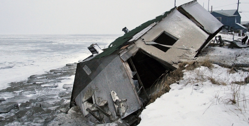 In this Dec. 2006 photo, an abandoned house at the west end of Shishmaref, Alaska, sits on the beach after sliding off during a fall storm in 2005. (AP Photo/Diana Haecker, File)