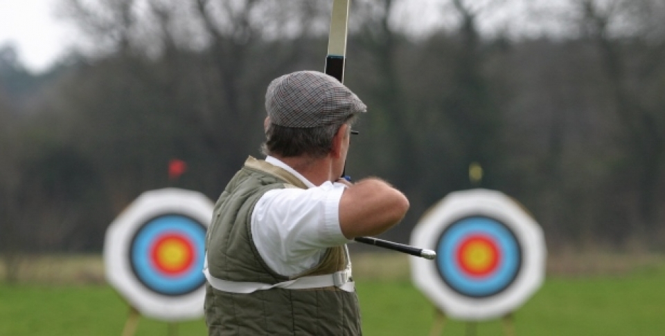 A sports archer aims at targets. (Shutterstock)