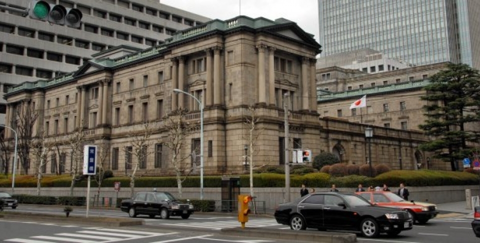 A Japanese flag is hoisted in front of the Bank of Japan headquarters in Tokyo. (AP Photo/Katsumi Kasahara)