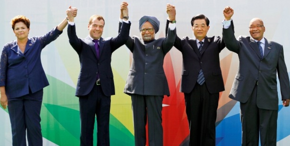 Leaders raise their arms together during the group picture for the BRICS 2012 Summit in New Delhi, India (AP Photo/Saurabh Das).