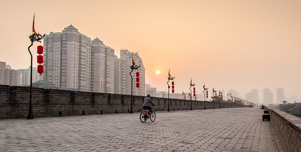 A bicycle rides at sunset in Xian, China. (Shutterstock)