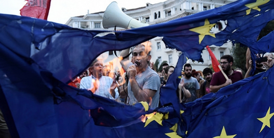 Members of left wing parties burn a European Union flag during a protest in the northern Greek port city of Thessaloniki. (AP Photo/Giannis Papanikos)
