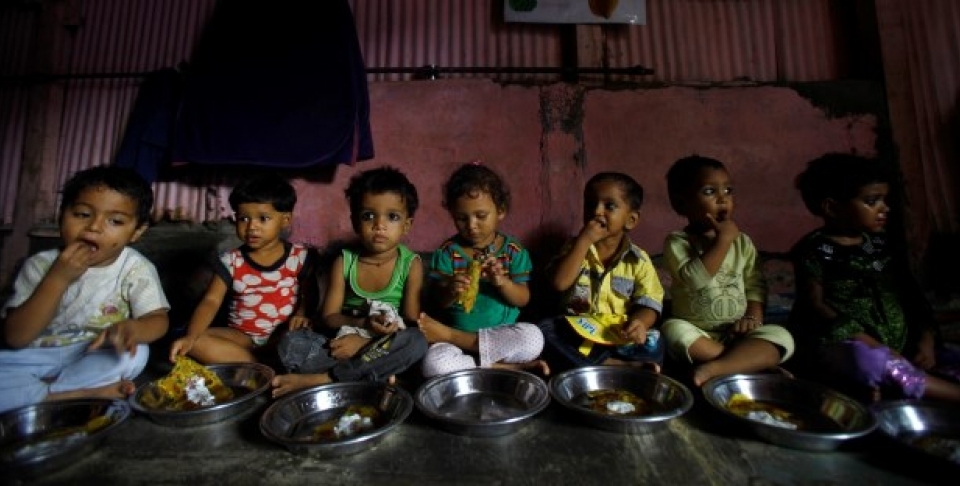 Malnourished Indian children eat a meal at the Apanalaya center, an organization working for the betterment of slum children, in Mumbai,India. (AP Photo/Rafiq Maqbool)