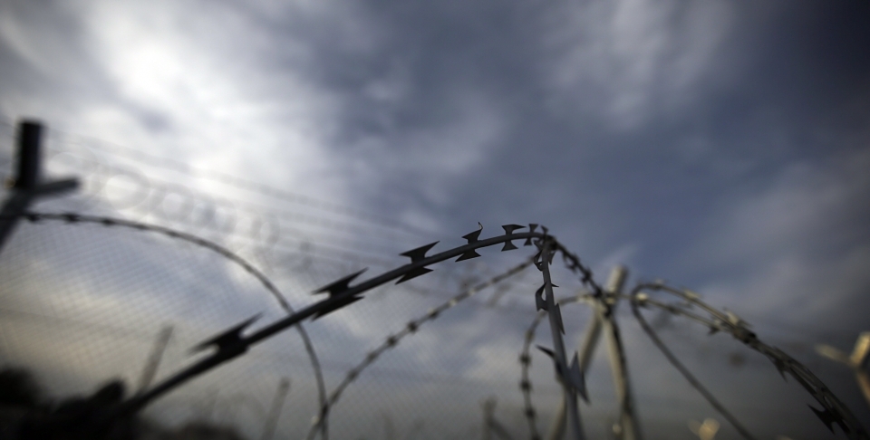 The barbed wire of a border fence by a makeshift camp near a border crossing at Idomeni, Greece (AP Photo/Gregorio Borgia)