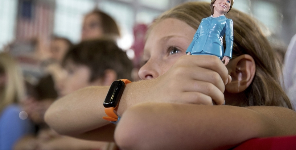 A girl in the audience holds a figurine at a rally in Akron, Ohio (AP Photo/Andrew Harnik)