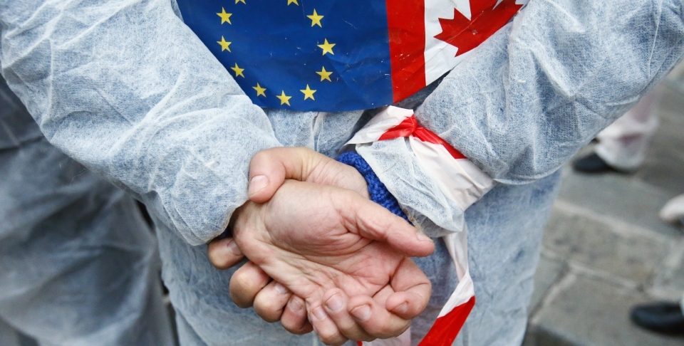 An activist protests the EU trade deal with Canada (AP Photo/Francois Mori)