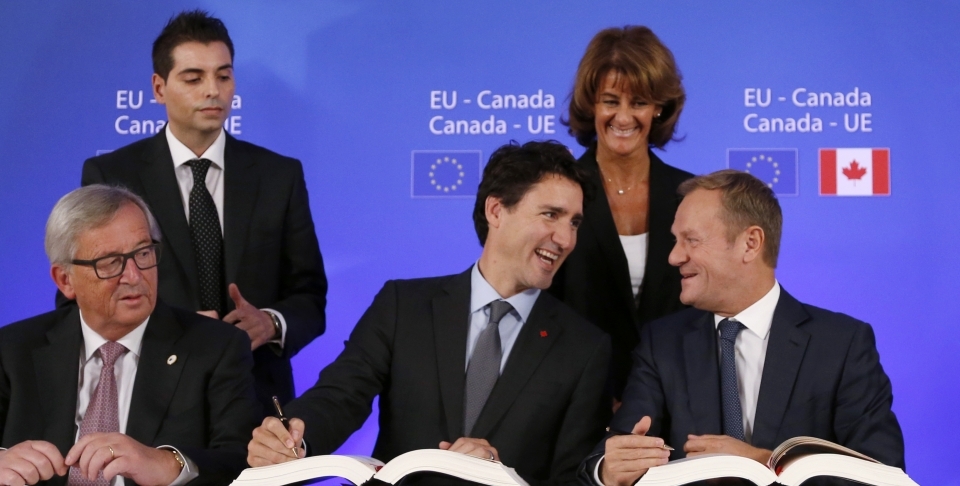 Prime Minister Justin Trudeau sits with European Council President Donald Tusk as they sign the Comprehensive Economic and Trade Agreement (CETA). (Francois Lenoir/AP Photo)