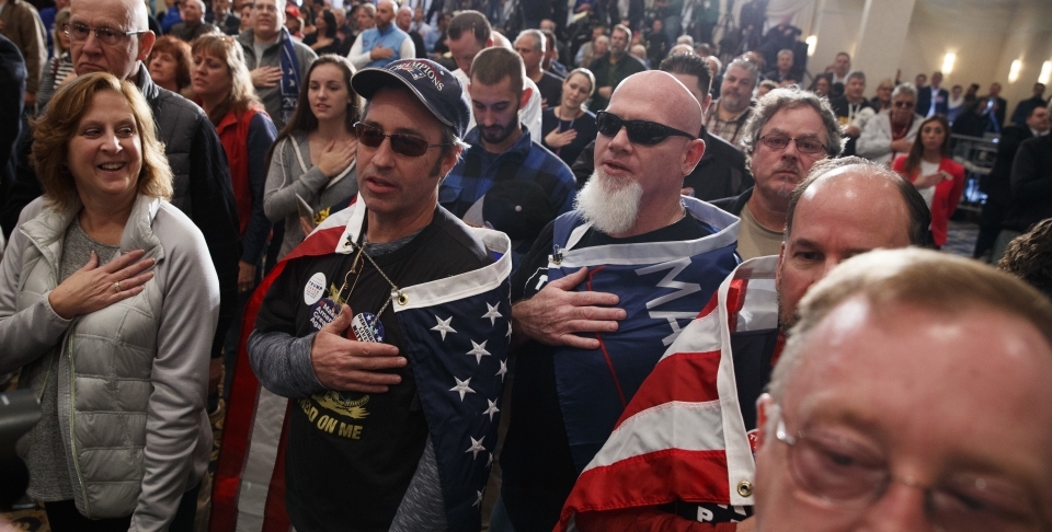 Supporters say the pledge of allegiance during a campaign rally (AP Photo/ Evan Vucci)