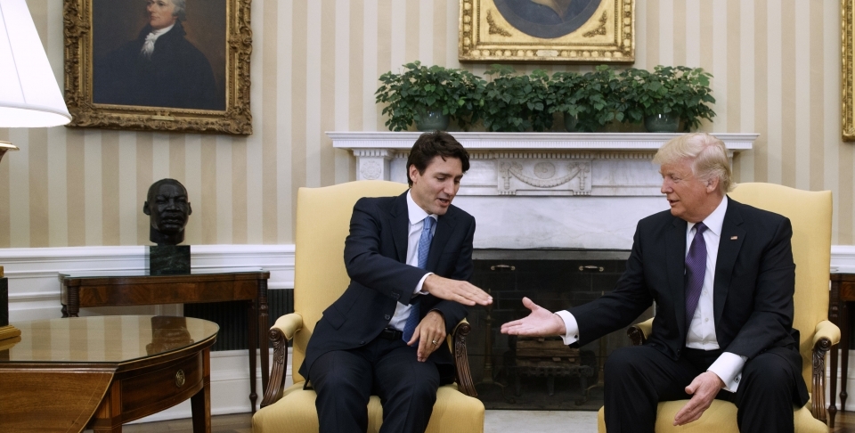 President Donald Trump reaches to shake hands with Canadian Prime Minister Justin Trudeau (AP Photo/Evan Vucci)