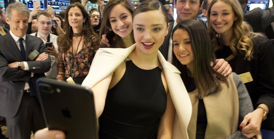 Model Miranda Kerr takes selfie during NYSE opening bell to mark Snap IPO. Kerr is engaged to Snap CEO Evan Spiegel. (AP Photo/Mark Lennihan)