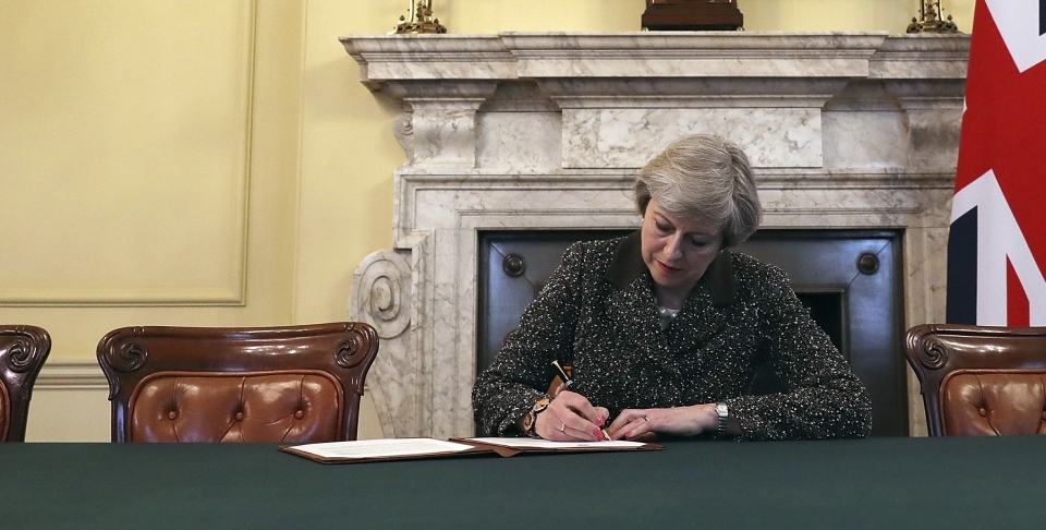 British Prime Minister Theresa May signs the official letter to European Council President Donald Tusk invoking article 50 (Christopher Furlong/Pool Photo via AP)