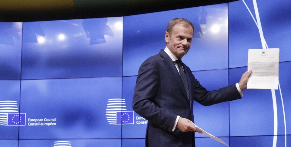 European Council President Donald Tusk holds a letter signed by UK Prime Minister Theresa May starting the clock on Brexit (AP Photo/Olivier Matthys)