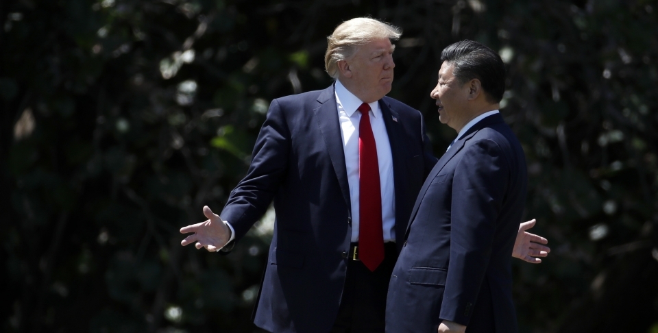 President Donald Trump gestures as he and Chinese President Xi Jinping walk together after their meetings at Mar-a-Lago, Friday, April 7, 2017, in Palm Beach, Fla. (AP Photo/Alex Brandon)