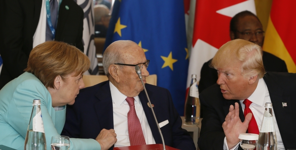 German Chancellor Angela Merkel and US President Donald Trump speak with Tunisian President Beji Caid Essebsi at roundtable during summit in Italy (AP Photo/Domenico Stinellis)