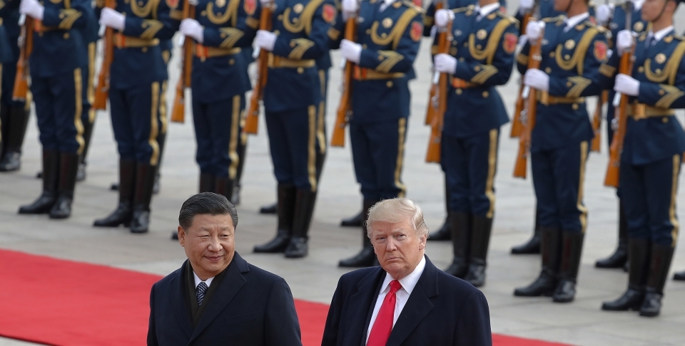 US President Donald Trump walks with Chinese President Xi Jinping during a welcome ceremony at the Great Hall of the people in Beijing, Thursday, Nov. 9, 2017. (AP Photo/Andy Wong)