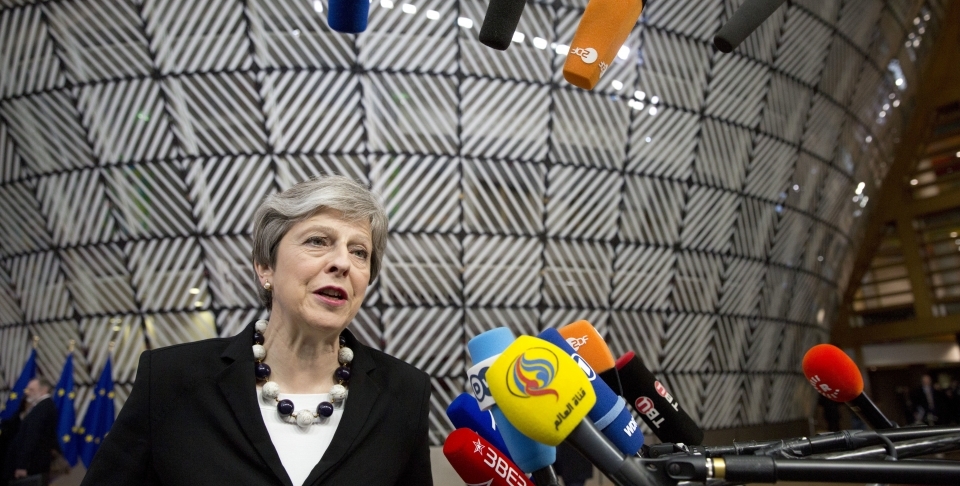 British Prime Minister Theresa May speaks with the media as she arrives for an EU summit at the Europa building in Brussels on March 23, 2018. (AP Photo/Virginia Mayo)