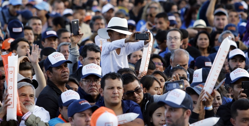 Supporters listen to Ivan Duque, presidential candidate for Democratic Center party, during his campaign rally in Bogota, Colombia on May 20, 2018. (AP Photo/Fernando Vergara)