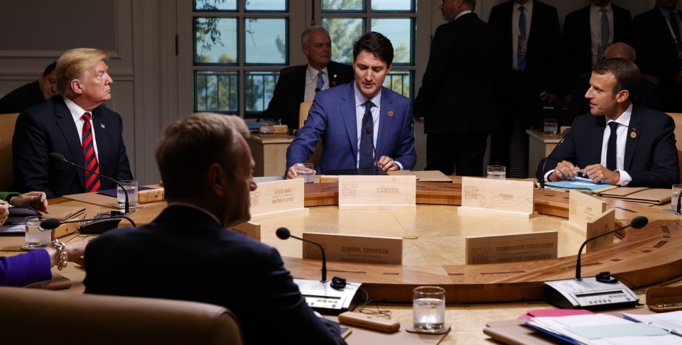 President Donald Trump talks with Canadian Prime Minister Justin Trudeau and French President Emmanuel Macron during a G7 Summit working session on June 8, 2018. (AP Photo/Evan Vucci)