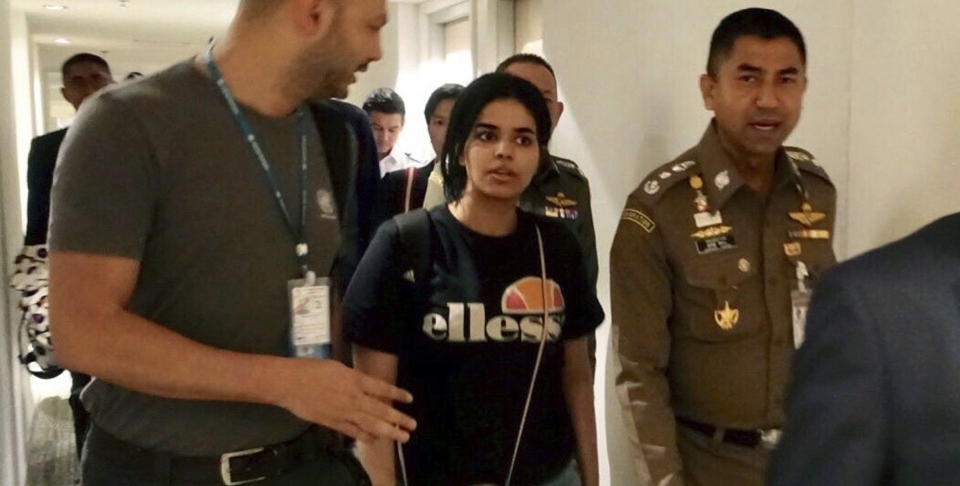 Rahaf Mohammed al-Qunun walks with immigration police before leaving the Suvarnabhumi Airport in Bangkok, Thailand on January 7, 2019. (Immigration police via AP, File)