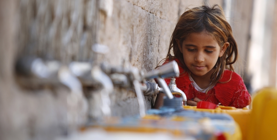 A girl fills a container with water from a public tap in the old city of Sanaa, Yemen (AP Photo/Hani Mohammed)