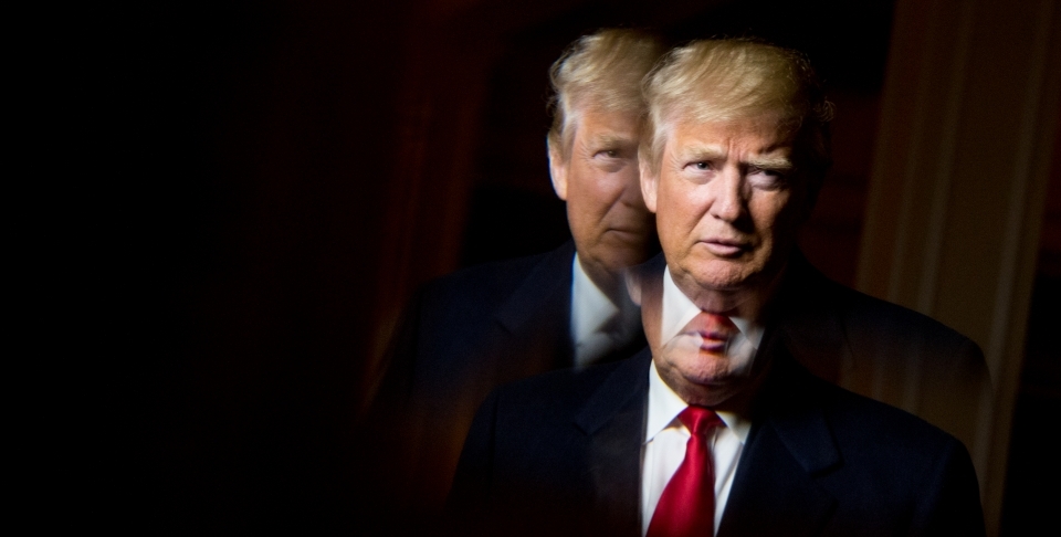 President-elect Donald Trump, seen in reflection, poses for a portrait (AP Photo/Andrew Harnik)