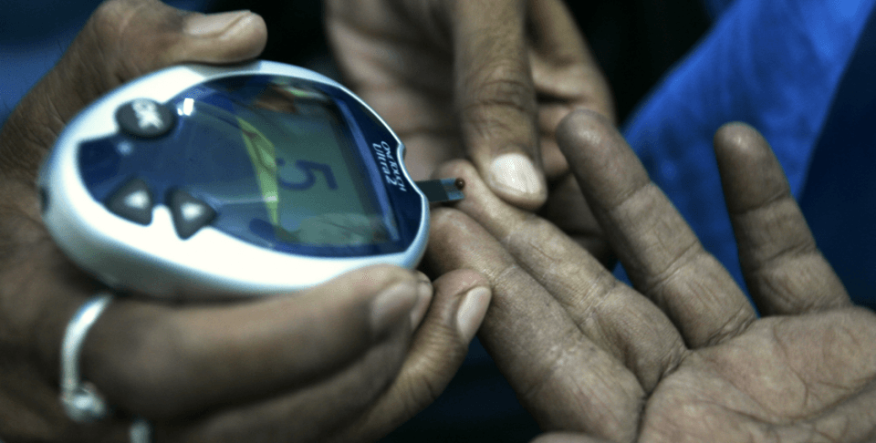 A health worker takes a blood sample from a diabetic patient (AP Photo/Bikas Das)