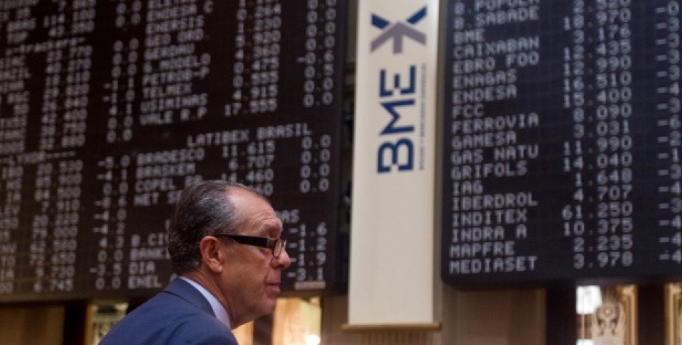 A broker looks on in front of a screen at the Stock Exchange in Madrid. (AP Photo/Paul White)