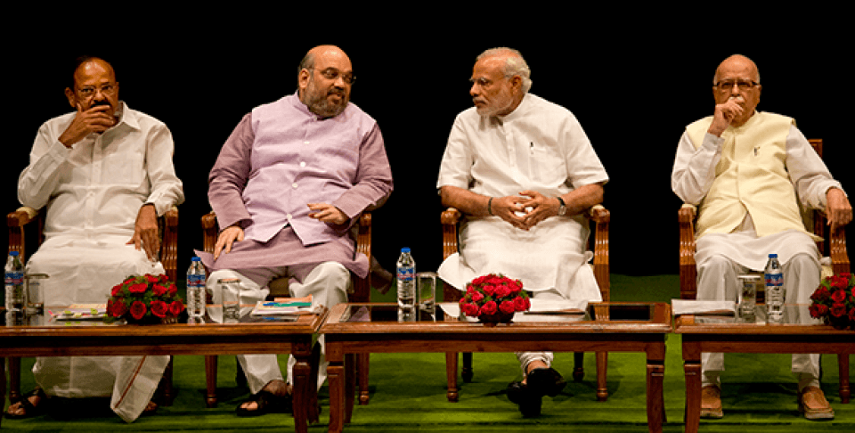 Indian Prime Minister Narendra Modi, second right, talks to Bharatiya Janata Party (BJP) president Amit Shah as party leaders Venkaiah Naidu, left and L.K.Advani, right sit beside during the BJP parliamentary party meeting before the start of second day of the monsoon session of parliament, in New Delhi, India, Wednesday, July 22, 2015.