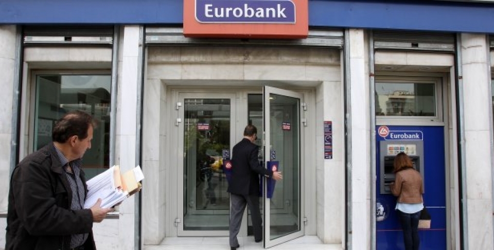 Customers use the ATM and enter a branch of Eurobank in central Athens. (AP Photo/Thanassis Stavrakis)