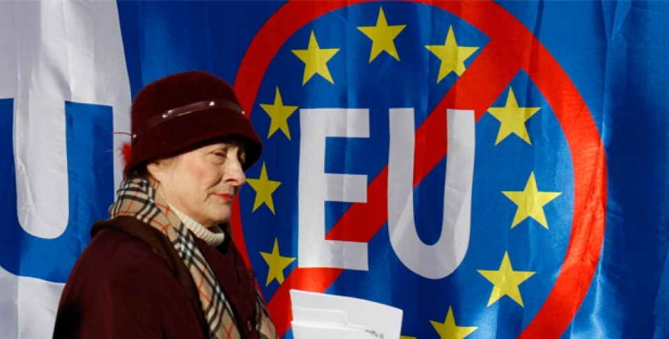 A woman walks past anti-EU banners during a protest in Zagreb, Croatia. Croatia signed an EU accession treaty in 2011 and is set to become a member in July 2013 (AP Photo/Filip Horvat).