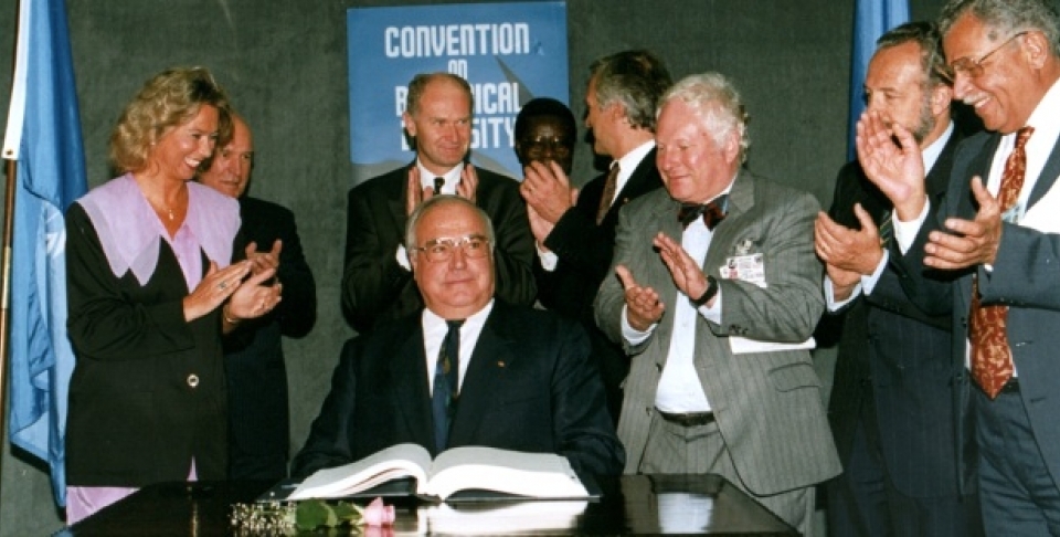 German Chancellor Helmut Kohl acknowledges the applause by a group of unidentified official observers after he has signed the biodiversity treaty at the Earth Summit in Rio de Janeiro. (AP Photo/Ricardo Mazalan/1992)