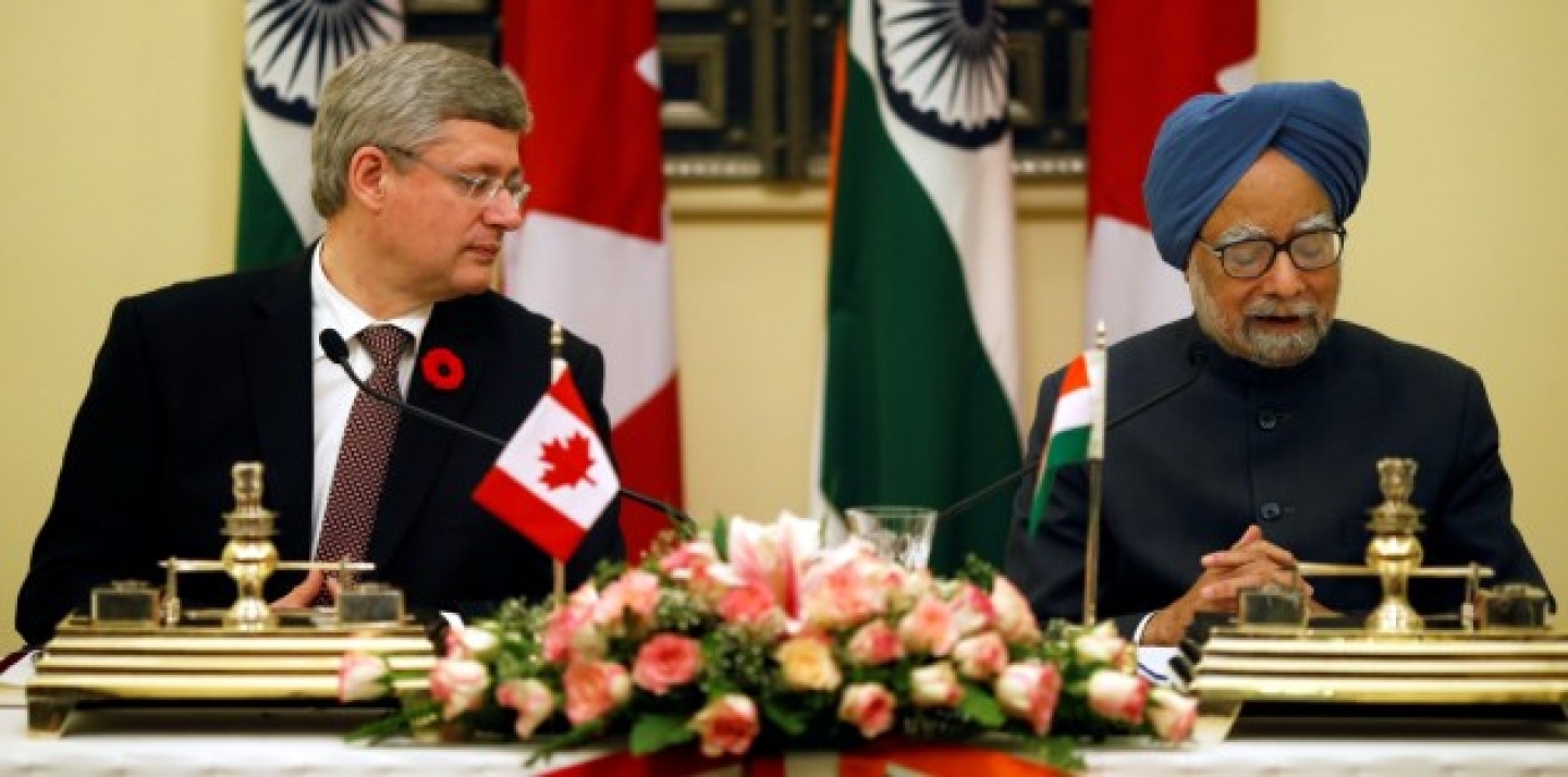 Indian Prime Minister Manmohan Singh, right, reads out a speech as his Canadian counterpart Stephen Harper looks towards him during signing of agreements between the two countries in New Delhi, India, Tuesday, Nov. 6, 2012. (AP Photo/Saurabh Das)