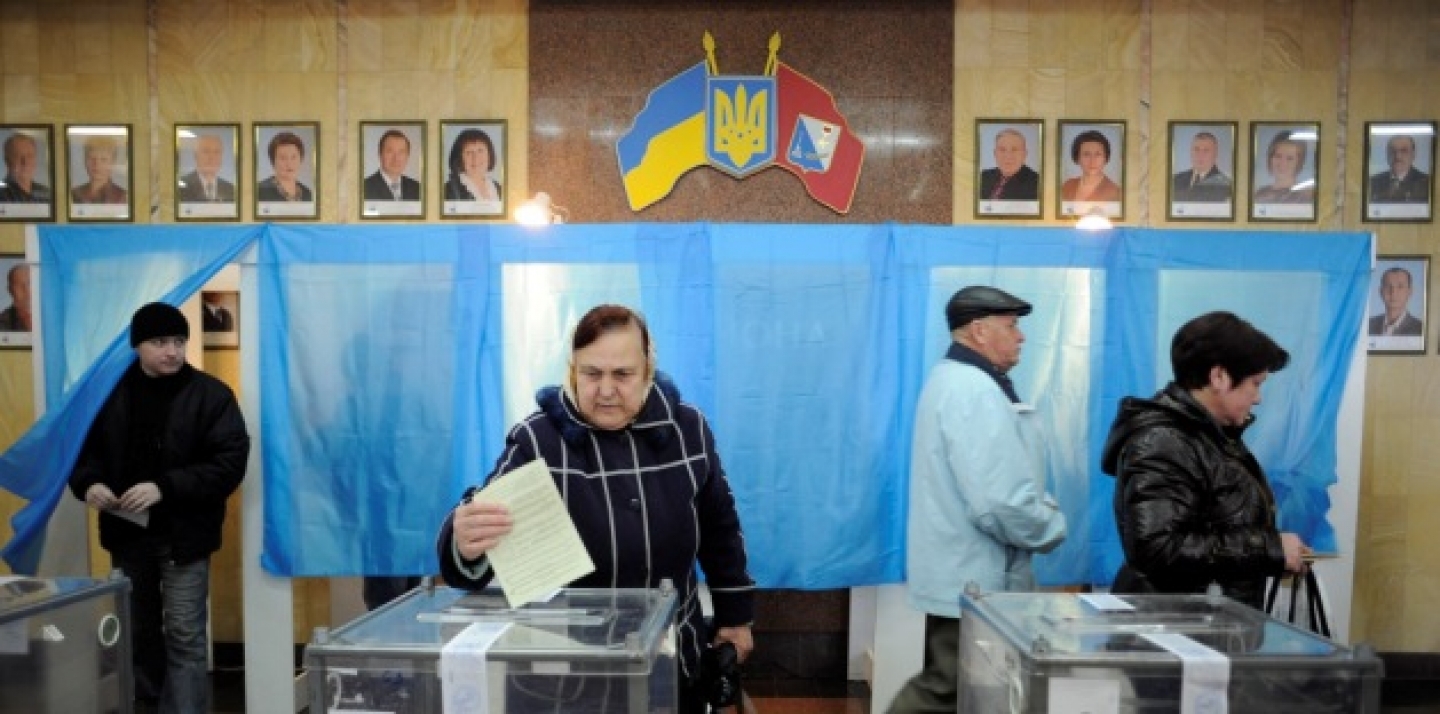 A woman casts her ballot at a polling station during the Crimean referendum, in Sevastopol, Ukraine, Sunday, March 16, 2014. Residents of Ukraine's Crimea region are voting in a contentious referendum on whether to split off and seek annexation by Russia. (AP Photo/Andrew Lubimov)