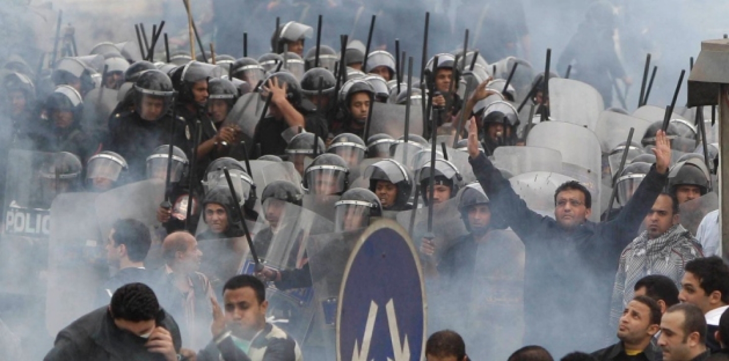 In this Jan. 28, 2011 photo, Egyptian anti-government activists clash with riot police in Cairo, Egypt. (AP Photo/Ben Curtis, File)