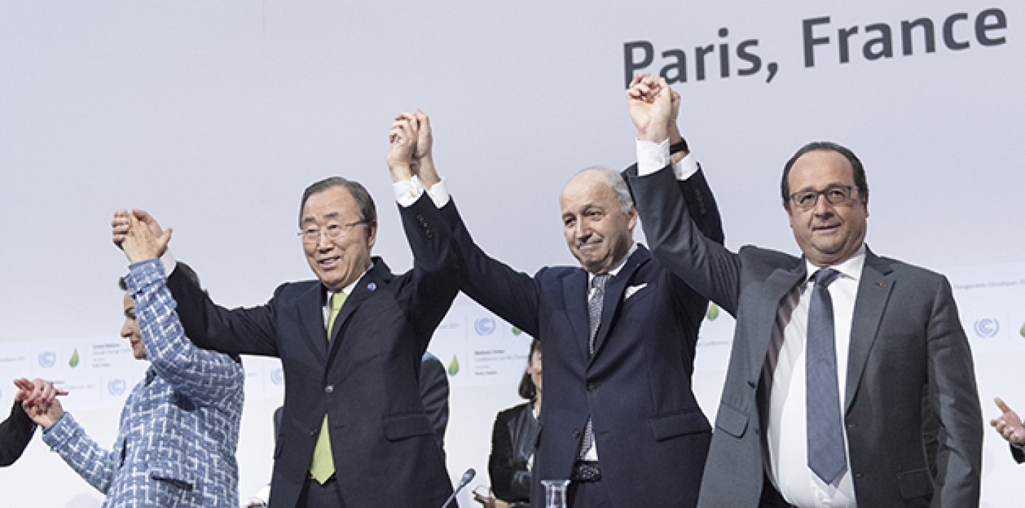 UN Secretary-General Ban Ki-moon, Christiana Figueres, Executive Secretary of the UNFCCC, Laurent Fabius, Minister for Foreign Affairs of France and President of COP21, and François Hollande, President of France celebrate after the historic adoption of Paris Agreement on climate change. (UN Photo/ Mark Garten)