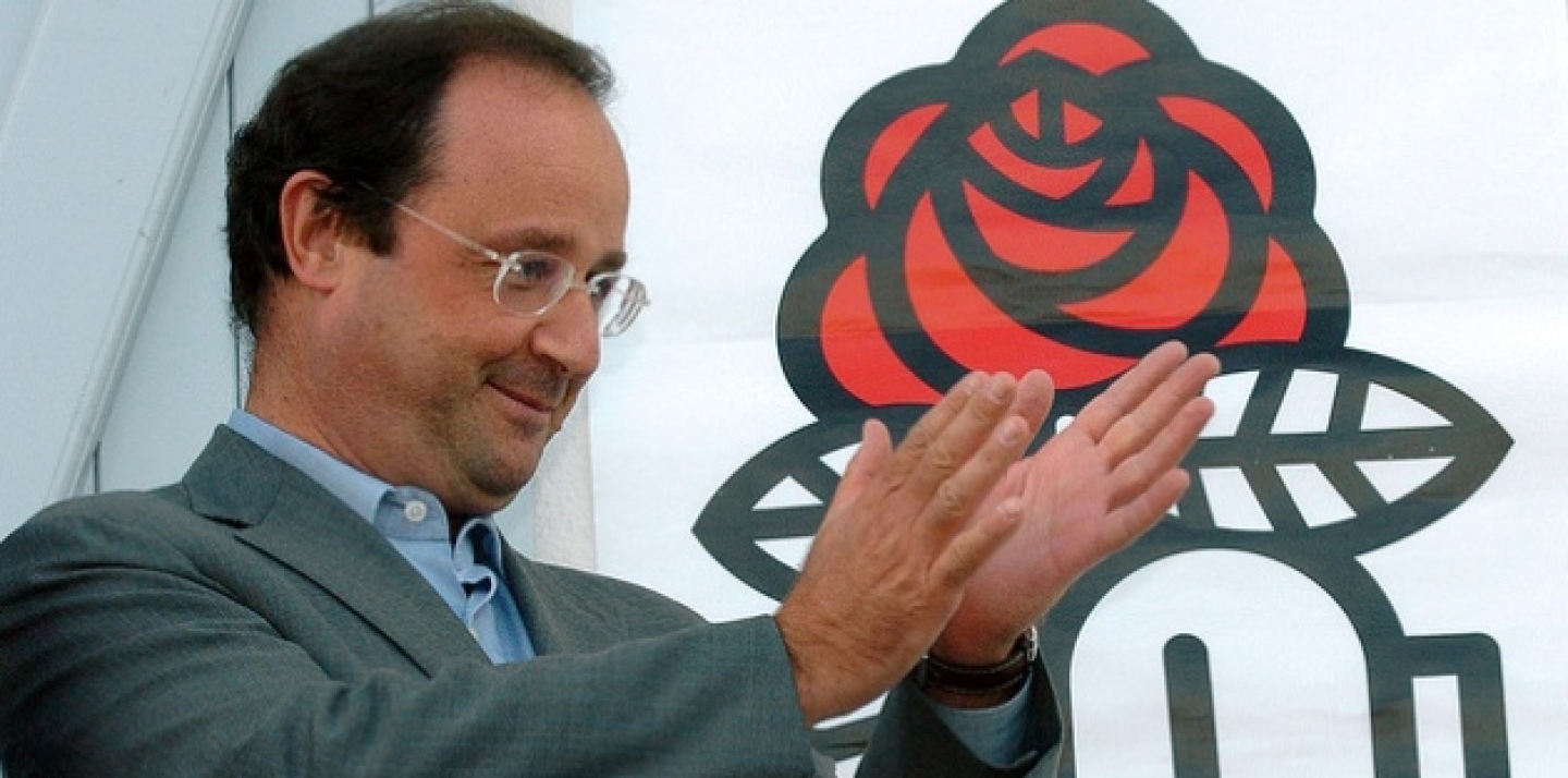 Francois Hollande, head of the French Socialist Party, applauds from the balcony of the Charentes Socialist Federation headquarters (AP Photo/Bob Edme)