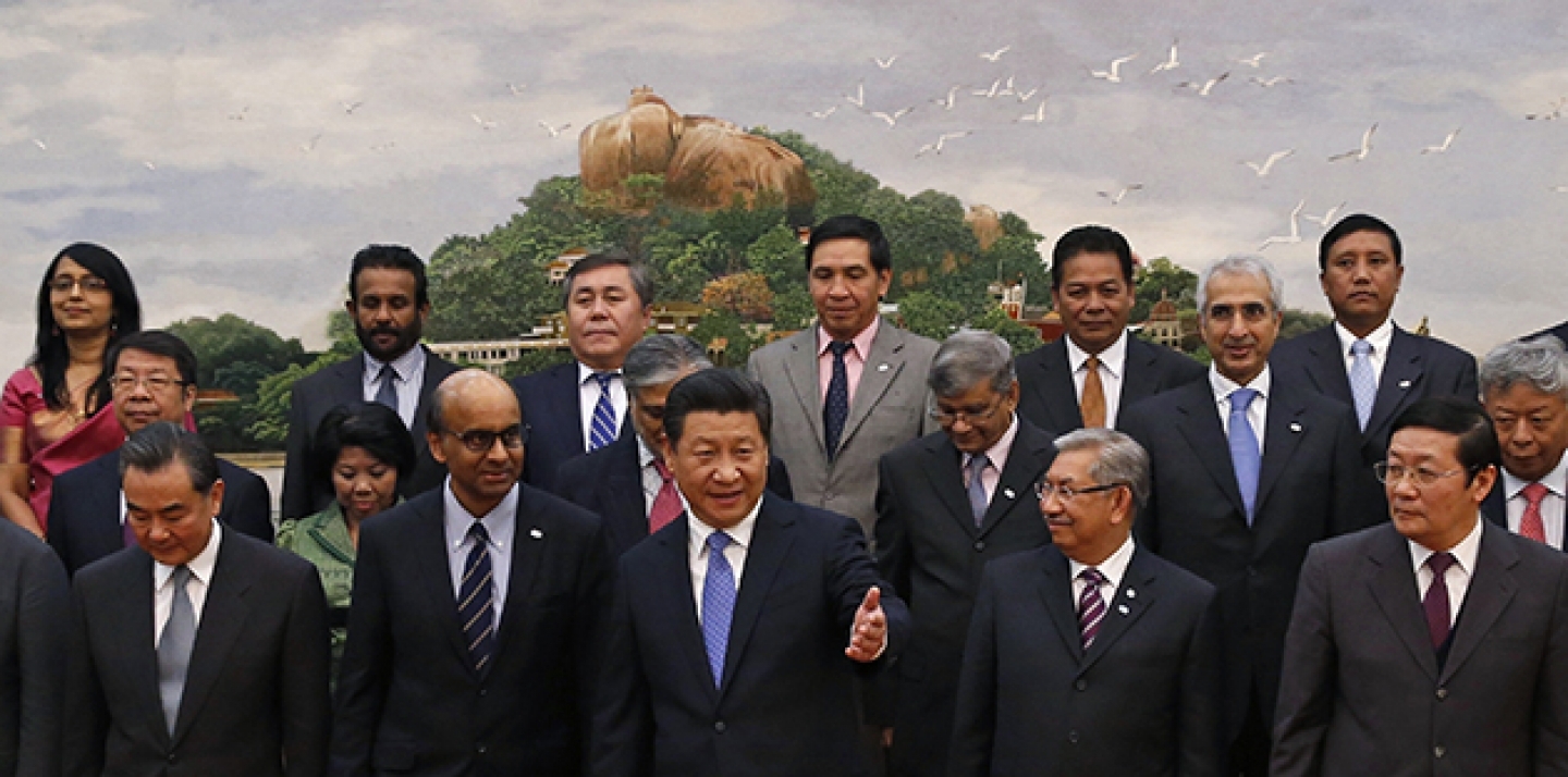 Chinese President Xi Jinping, center, shows the way to the guests who attended the signing ceremony of the Asian Infrastructure Investment Bank. (AP Photo/Takaki Yajima, Pool)