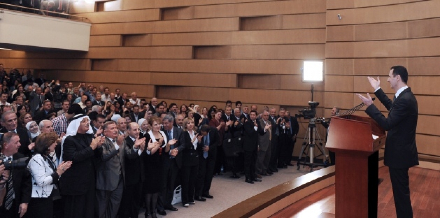 A crowd of supporters applaud Syria's President Bashar Assad as he delivers a speech at Damascus University, Monday, June 20, 2011. (AP Photo/SANA)