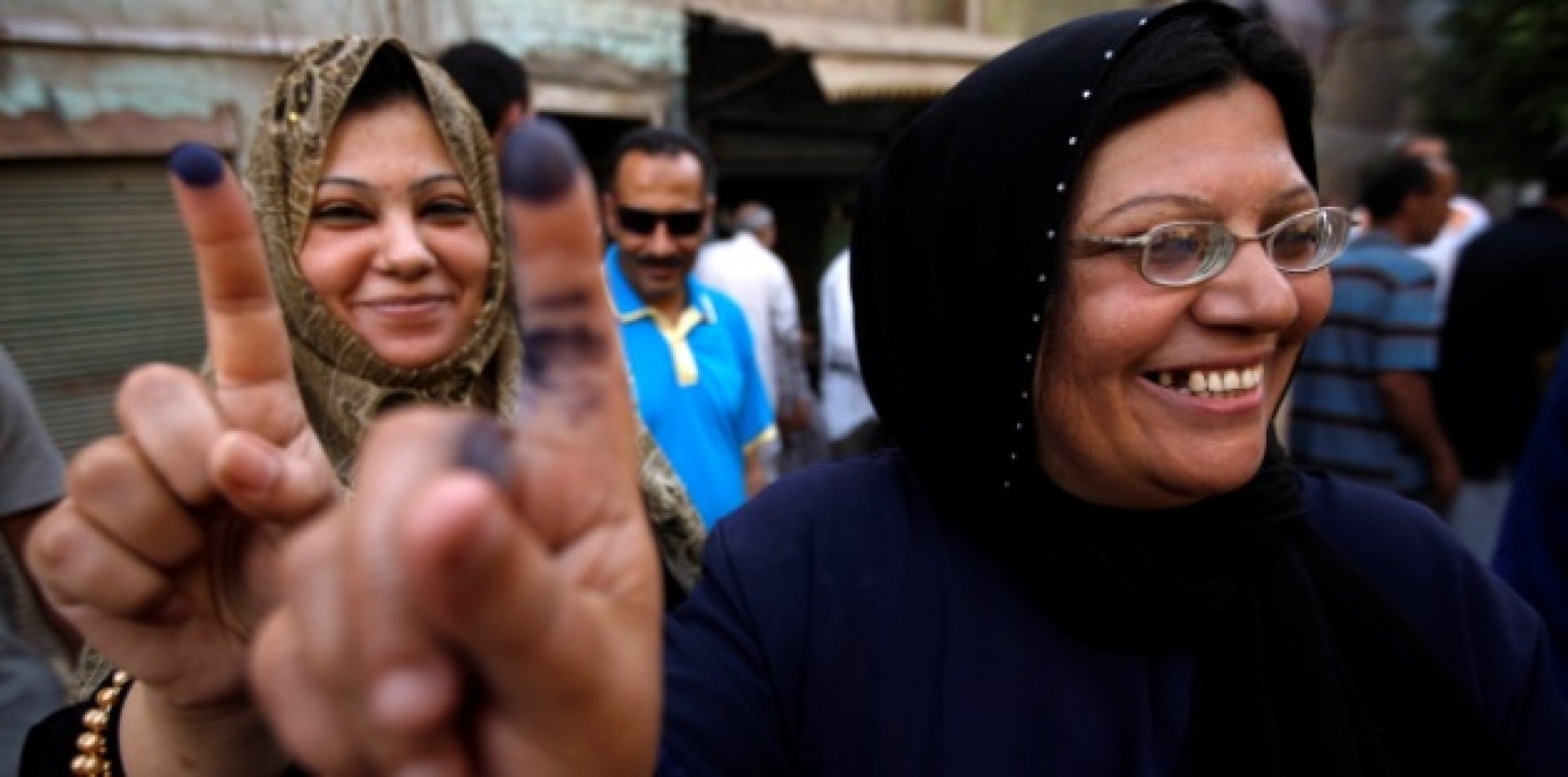 Two women show their inked fingers after casting their votes on the first day of the Presidential election at a polling center in Old Cairo, Egypt, Wednesday, May 23, 2012. (AP Photo/Fredrik Persson)
