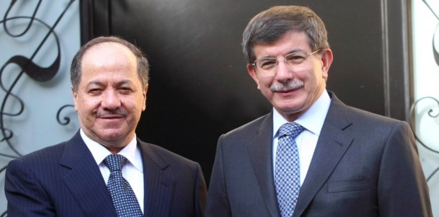 Iraqi Kurdish leader Massoud Barzani, left, and Turkish Foreign Minister Ahmet Davutoglu shake hands before a meeting in Ankara, Turkey, Oct. 1, 2012. (AP Photo)