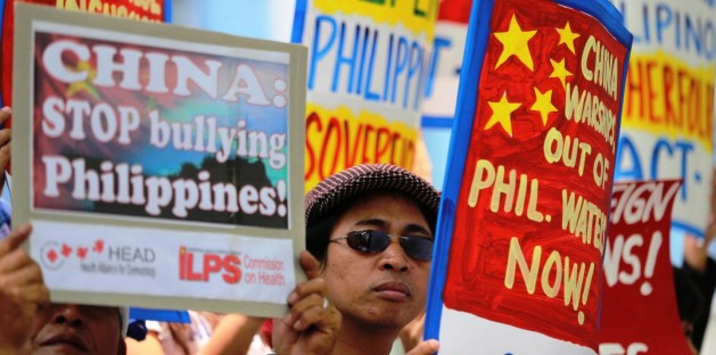 Filipino protesters hold placards with slogans outside the Chinese consulate at the financial district of Makati, south of Manila, Philippines on April 22, 2014. The group is demanding an end to China's alleged incursions in the South China Sea and to press the Chinese government to respect the arbitral process under the United Nations Convention on the Law of the Sea. (AP Photo/Aaron Favila)