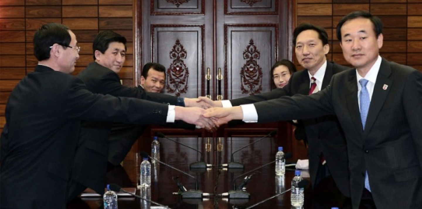 The head of South Korea’s working-level delegation Lee Duk-haeng, center right, shakes hands with his North Korean counterpart Park Yong Il, center left, during their meeting at Tongilgak in the North Korean side of Panmunjom, which has separated the two Koreas since the Korean War, Wednesday, Feb. 5, 2014. (AP Photo/South Korean Unification Ministry)