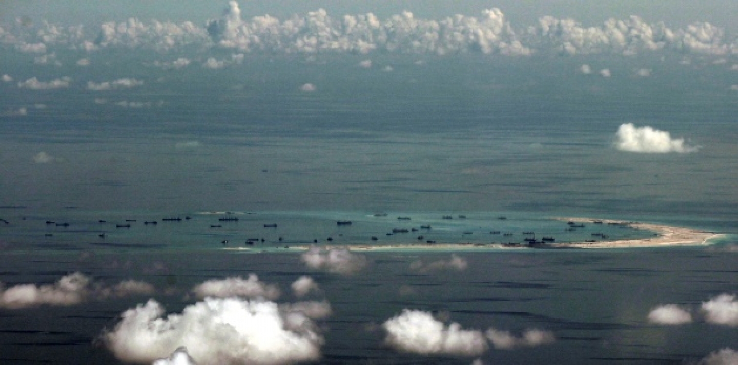 This photo, taken May 11, 2015, shows China's alleged on-going reclamation of Mischief Reef. The dispute over the strategic waterways of the South China Sea has intensified, pitting a rising China against its smaller and militarily weaker neighbors who all lay claim to a string of isles, coral reefs and lagoons known as the Spratly and the Paracel islands. (Ritchie B. Tongo/Pool Photo via AP)