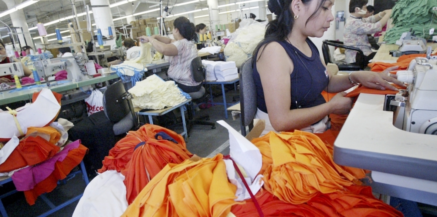 Workers sew at an American Apparel factory in Los Angeles. In an industry with a history of sweatshops, American Apparel is one of two Los Angeles firms convinced it can make money without underpaying or overworking employees. (AP Photo/Ric Francis)